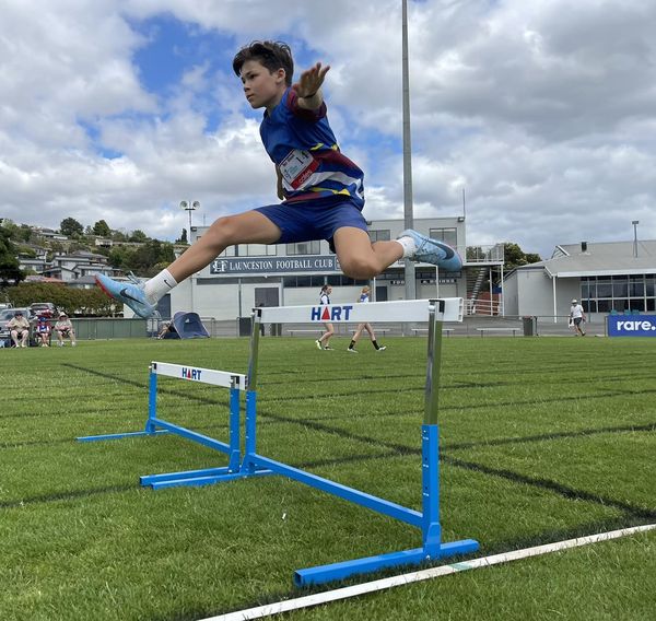 Athlete clearing a hurdle