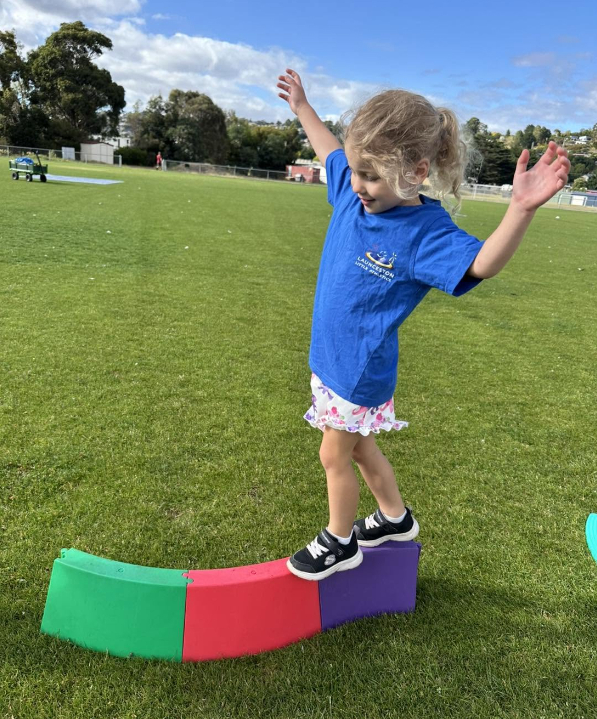Tiny Tot balancing on a coloured beam